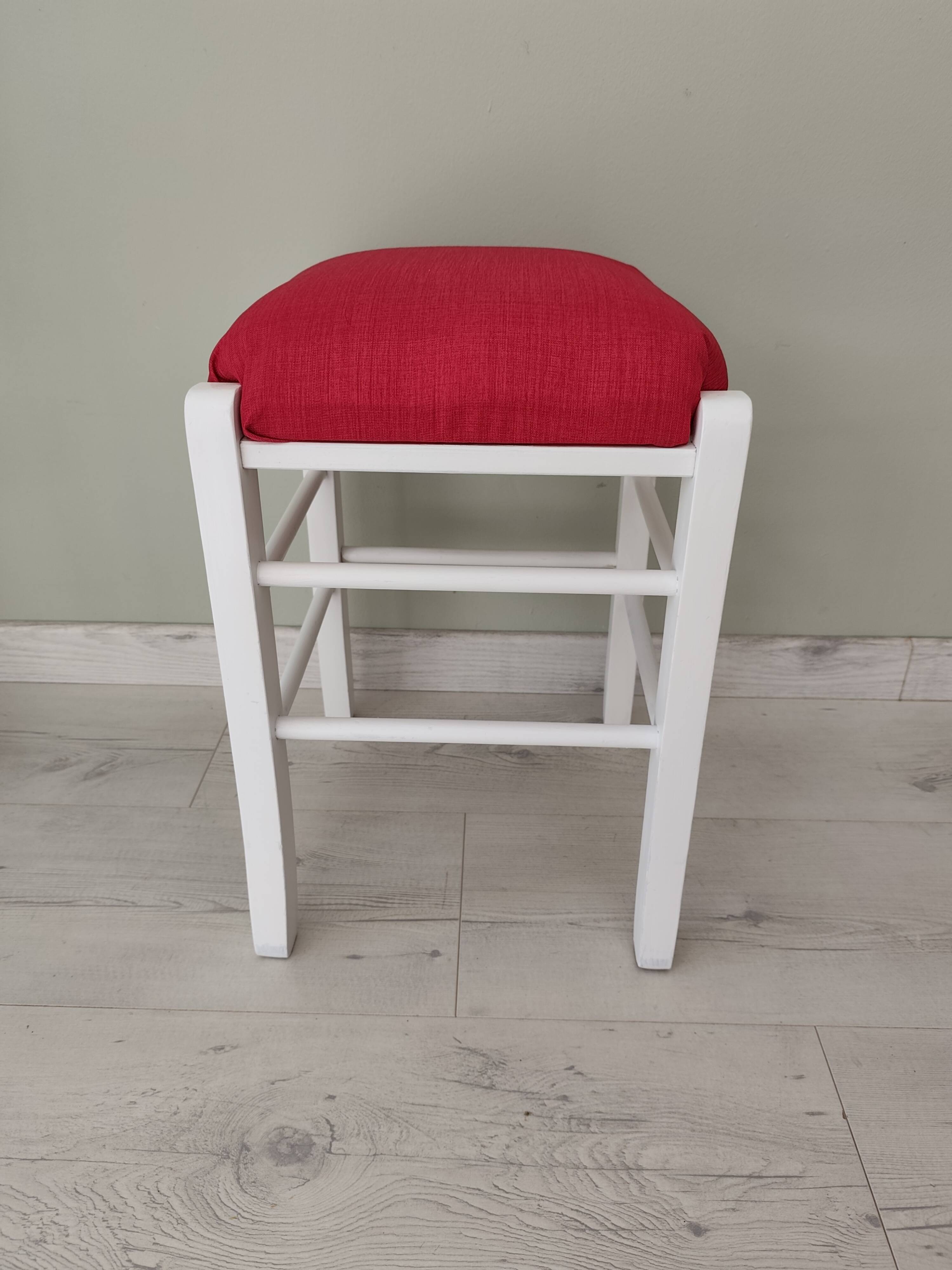 White pine stool with a red seat.
