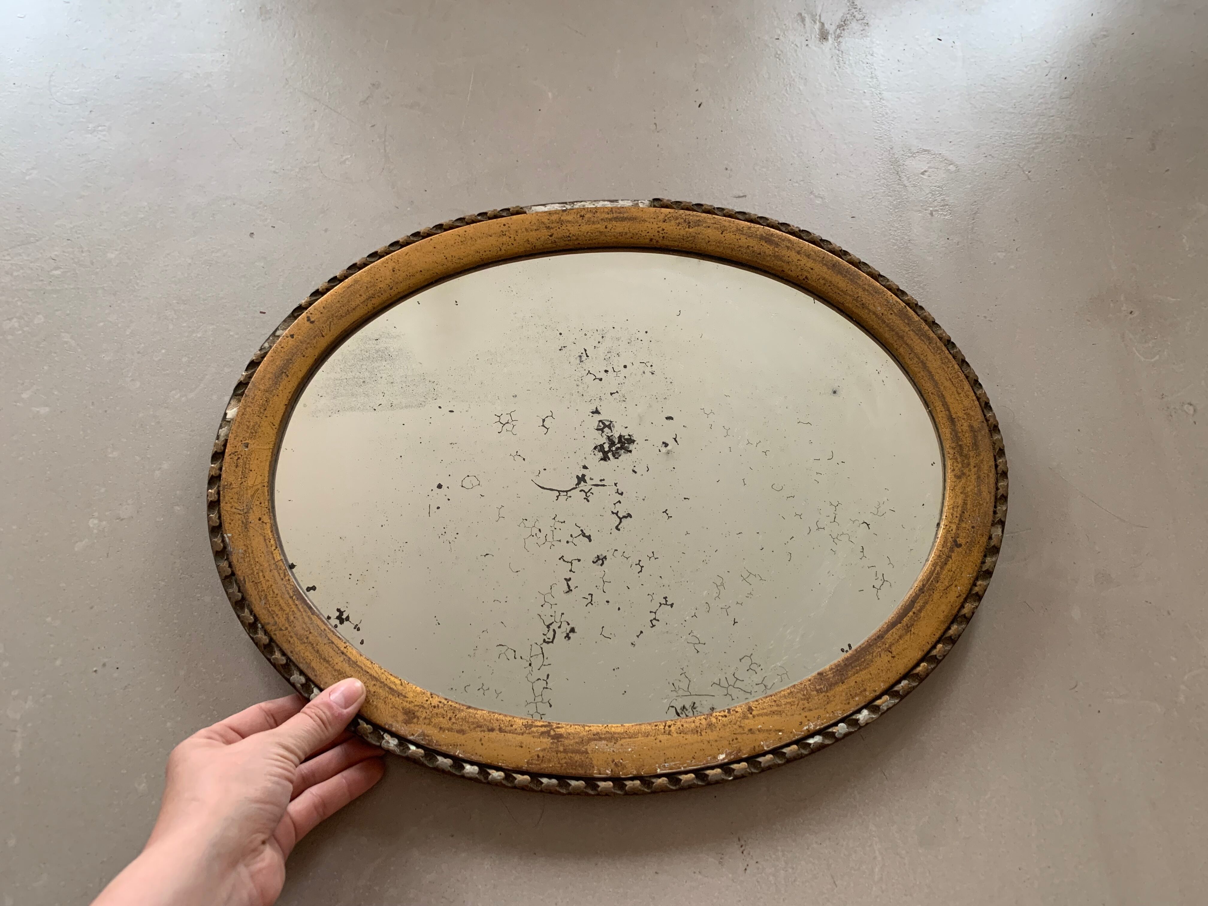 Old oval mirror stitched