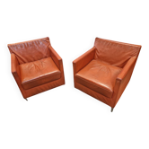 Pair of orange leather club chairs