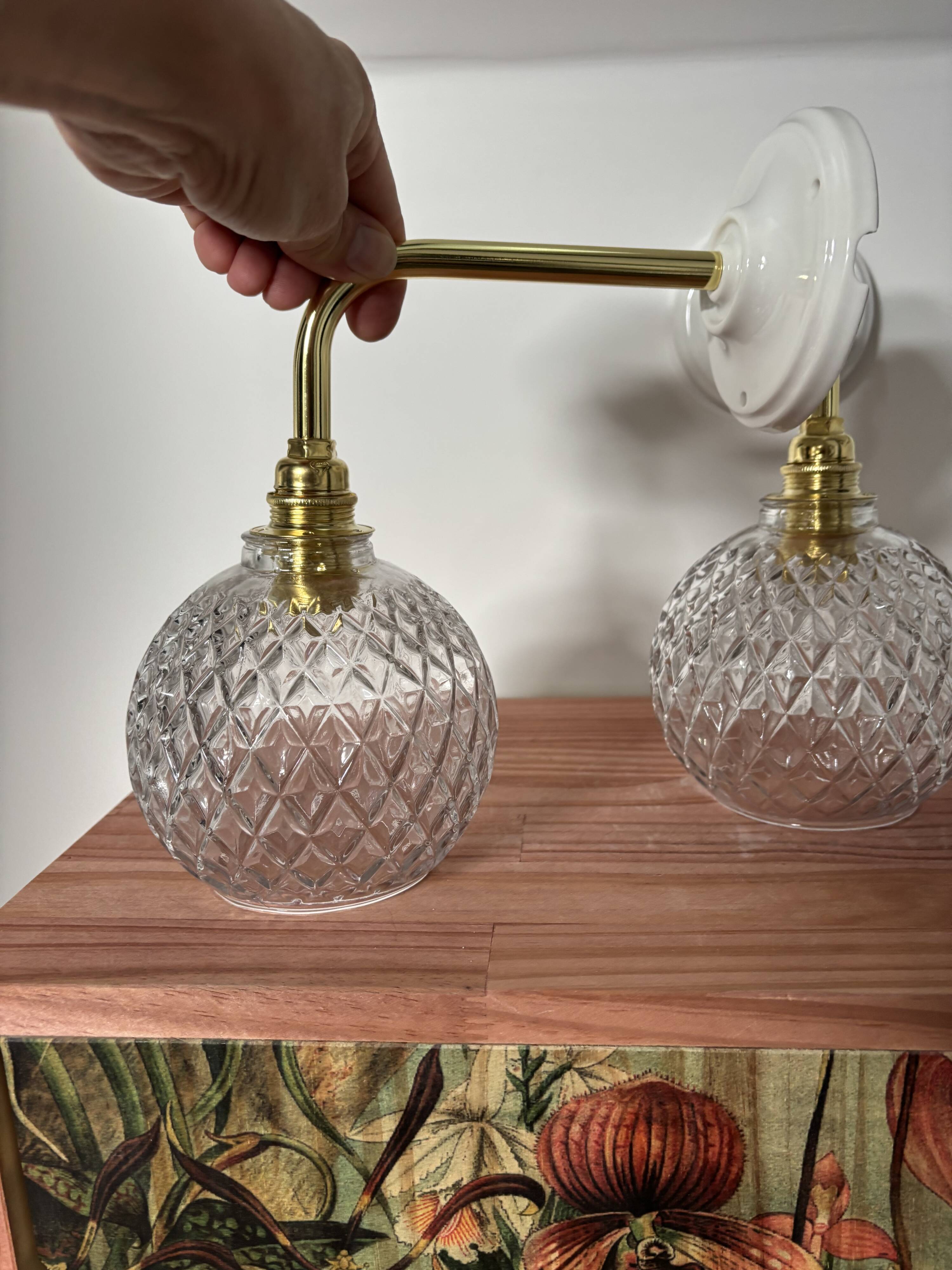 Pair of chiseled glass globe wall sconces