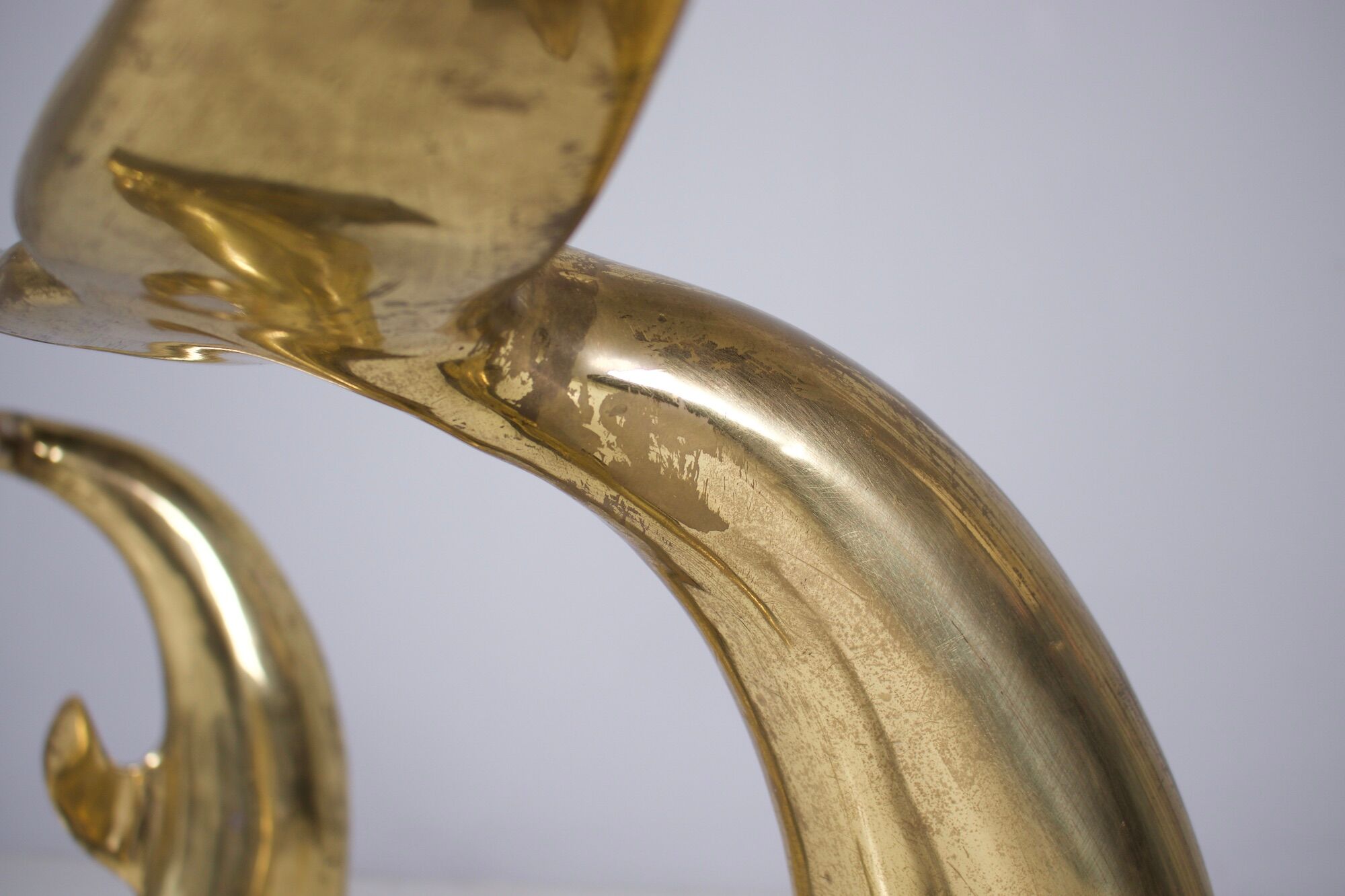 Solid brass dolphin console feet.