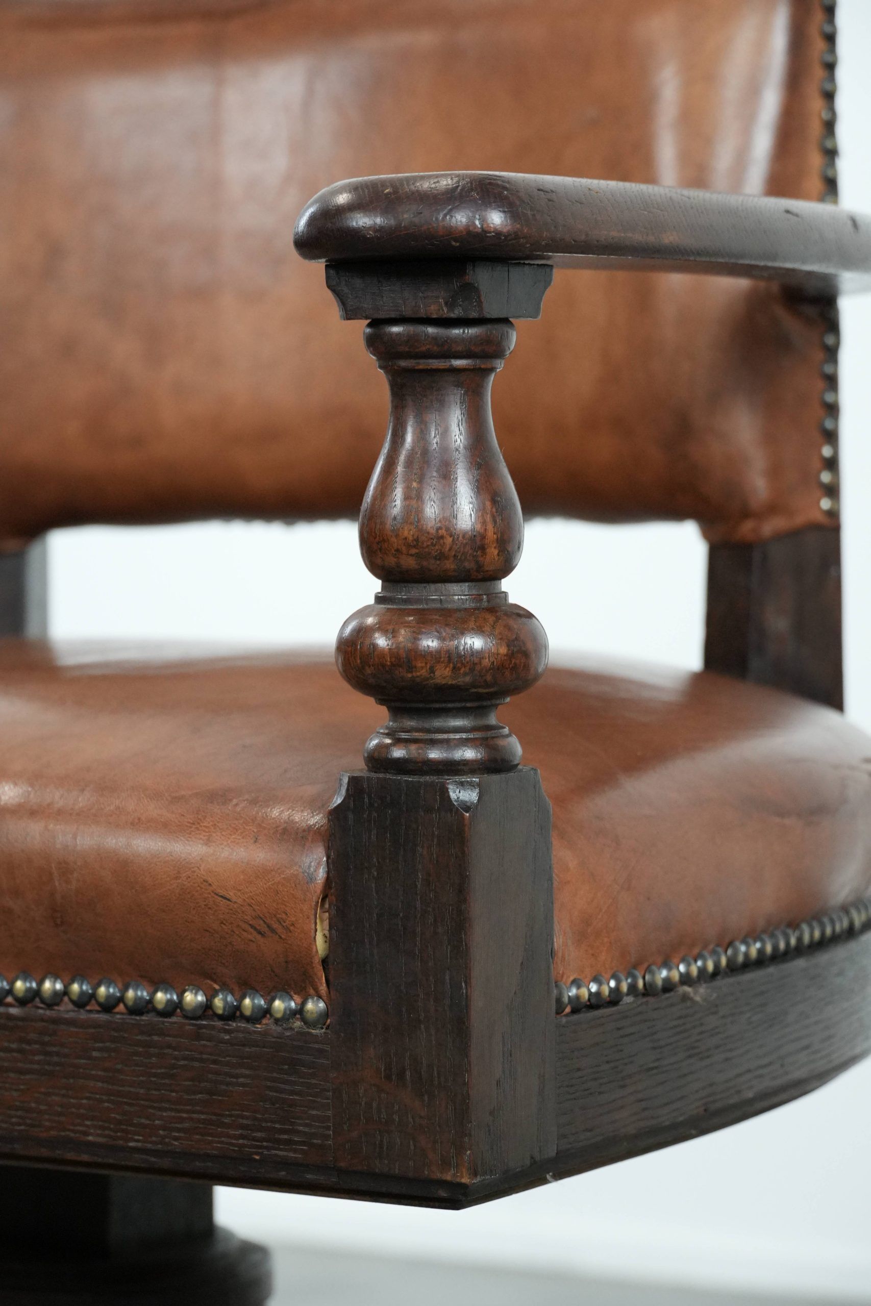 Elegant antique sheepskin leather desk chair with a heavy wooden frame