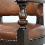 Elegant antique sheepskin leather desk chair with a heavy wooden frame