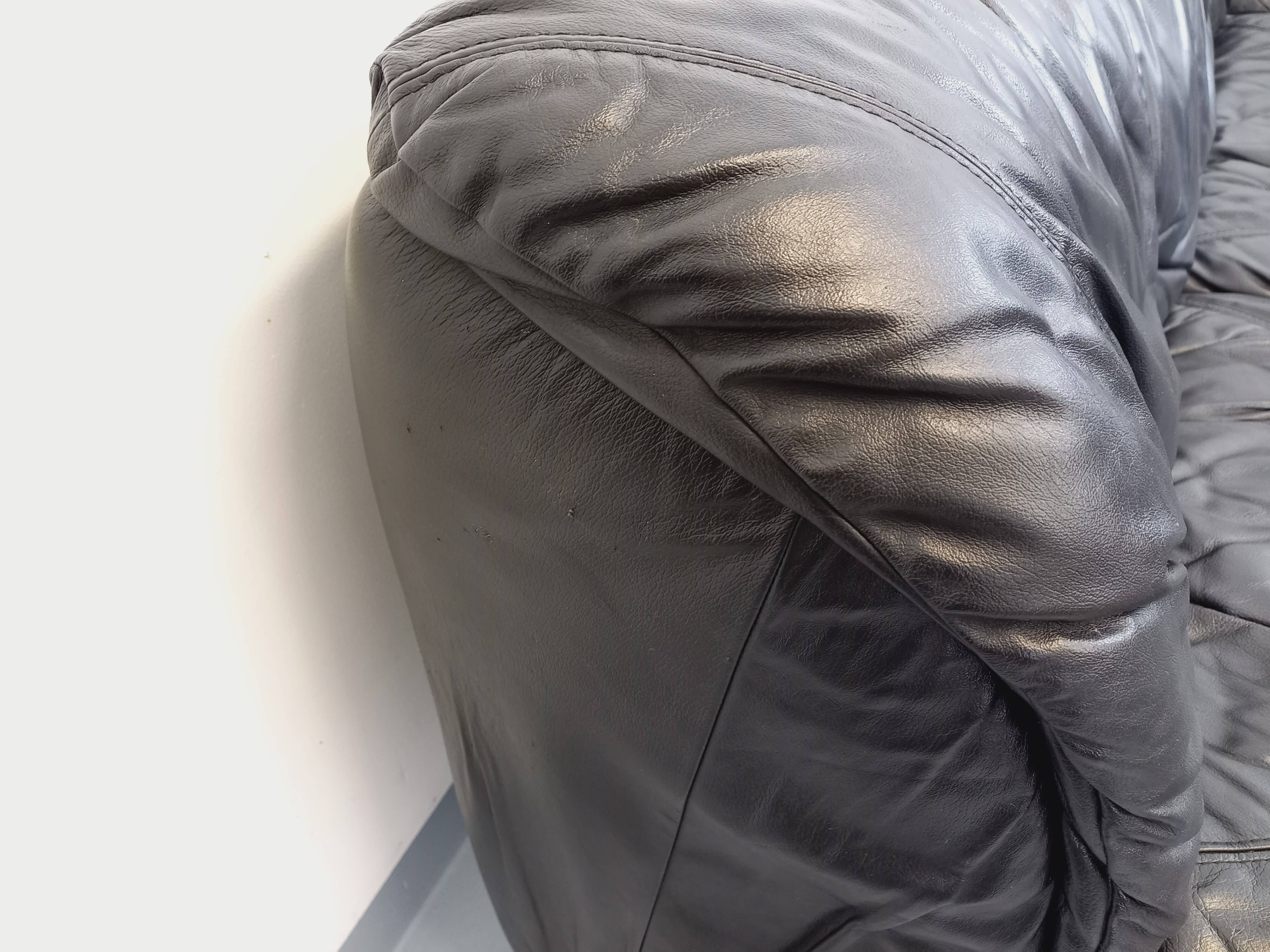 Vintage corner sofa composed of 3 modules in black leather with integrated bed.