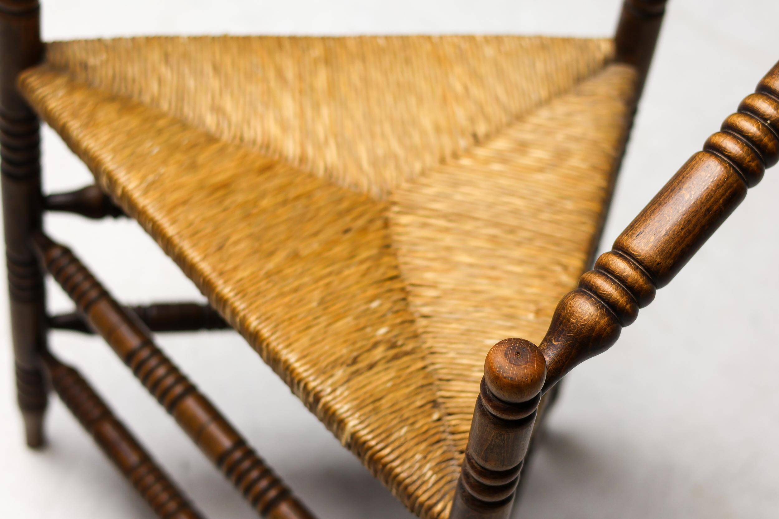 Mid Century Antiques spindle wood chaise with a rush seat.