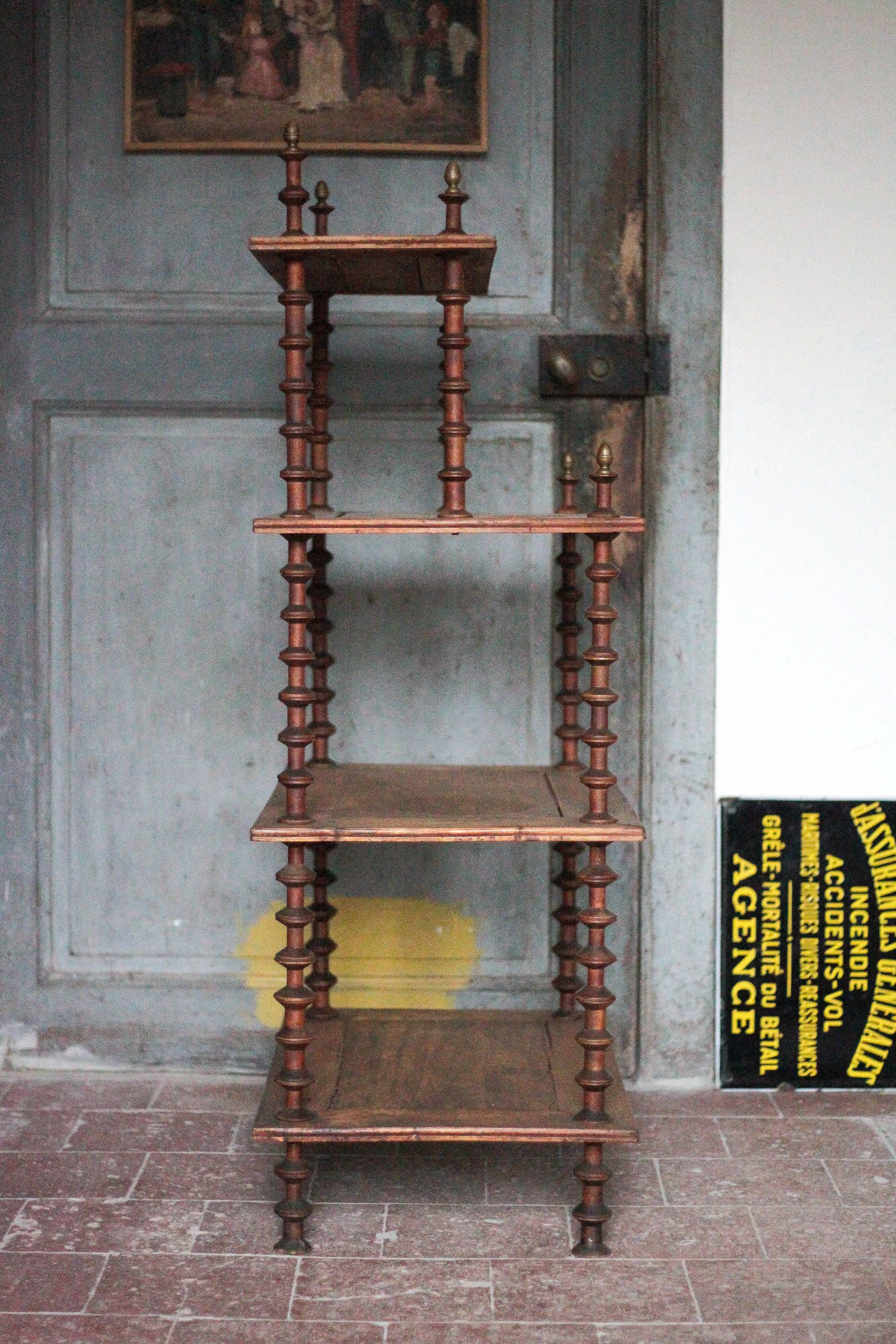 Napoleon III spool shelf, floor-standing shelf with brass tips.