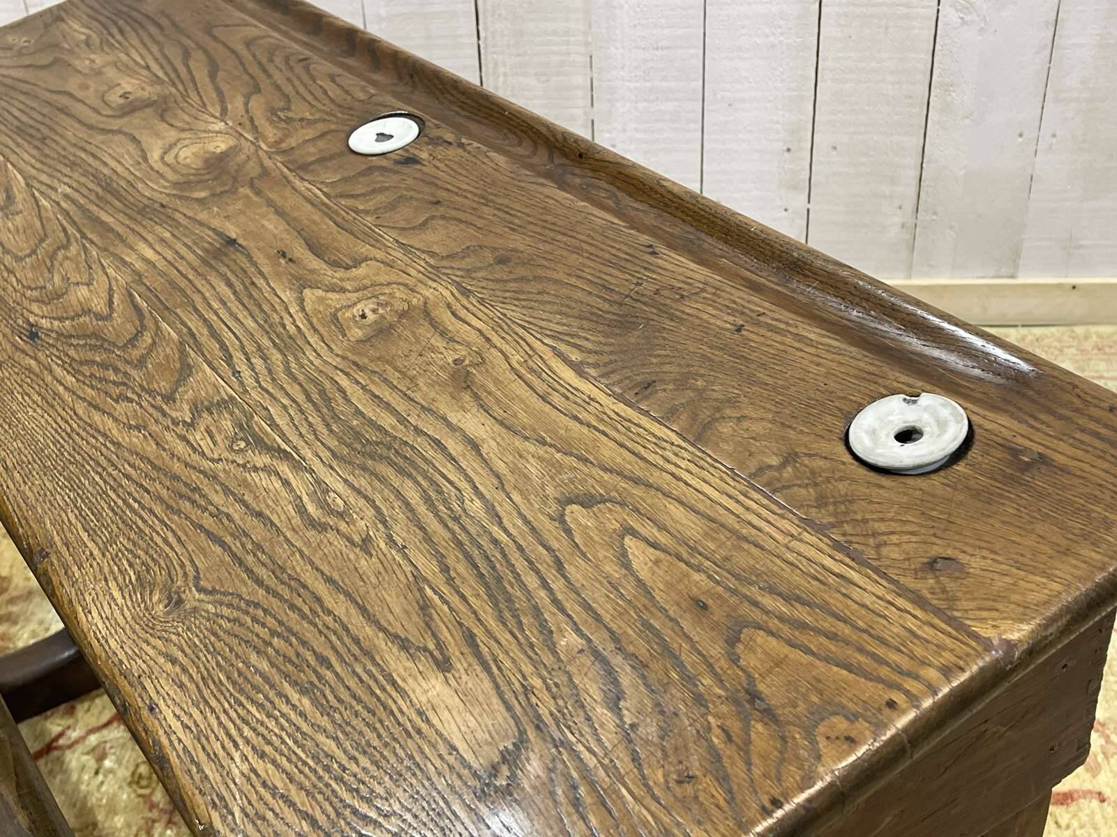 Early 20th-century oak school desk with porcelain inkwells