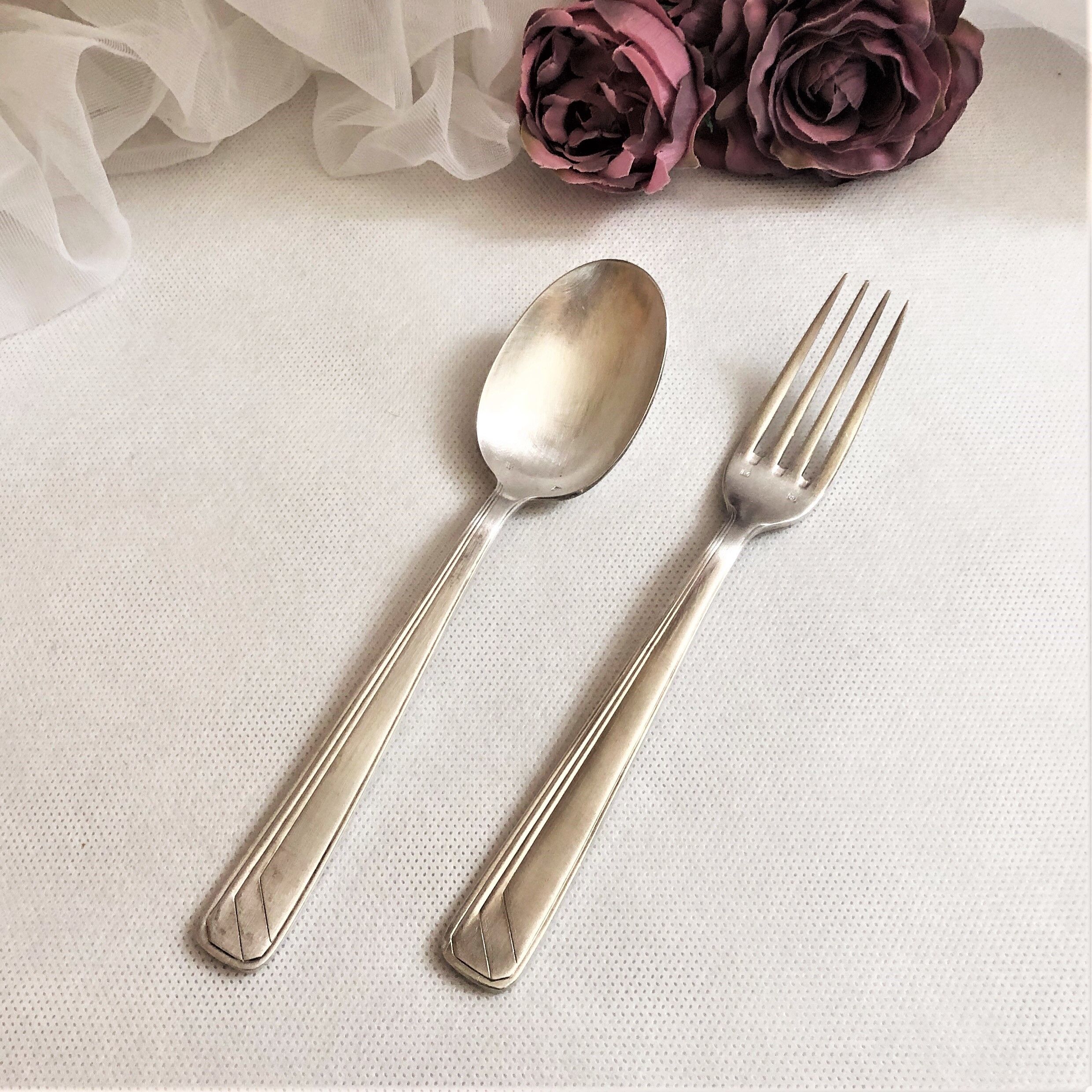 Set of 2 silver metal cutlery with punches