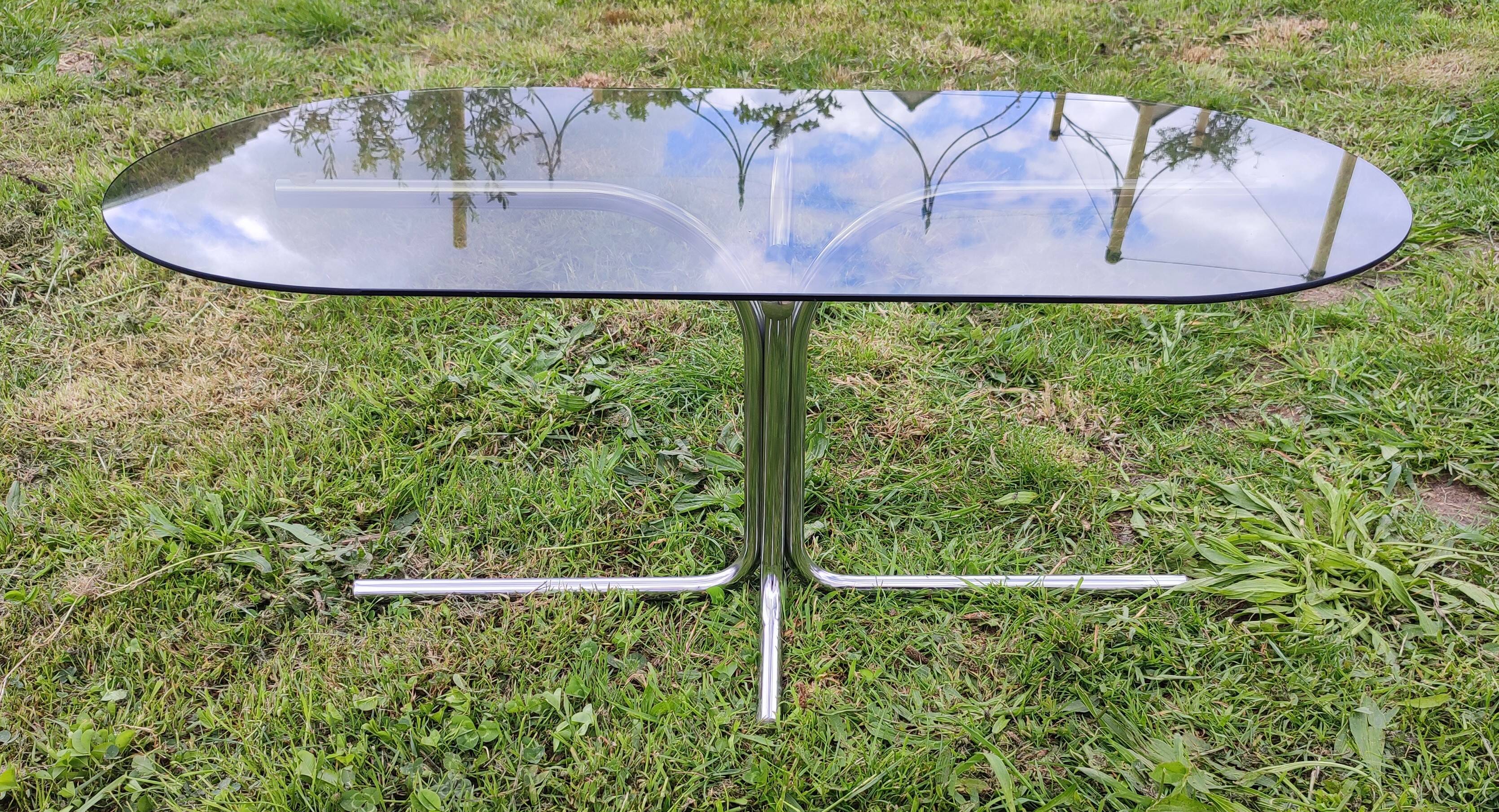 Vintage coffee table with metal tube structure and glass top.