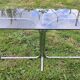 Vintage coffee table with metal tube structure and glass top.