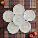 Vintage earthenware plates with a trompe l'oeil apple tart design