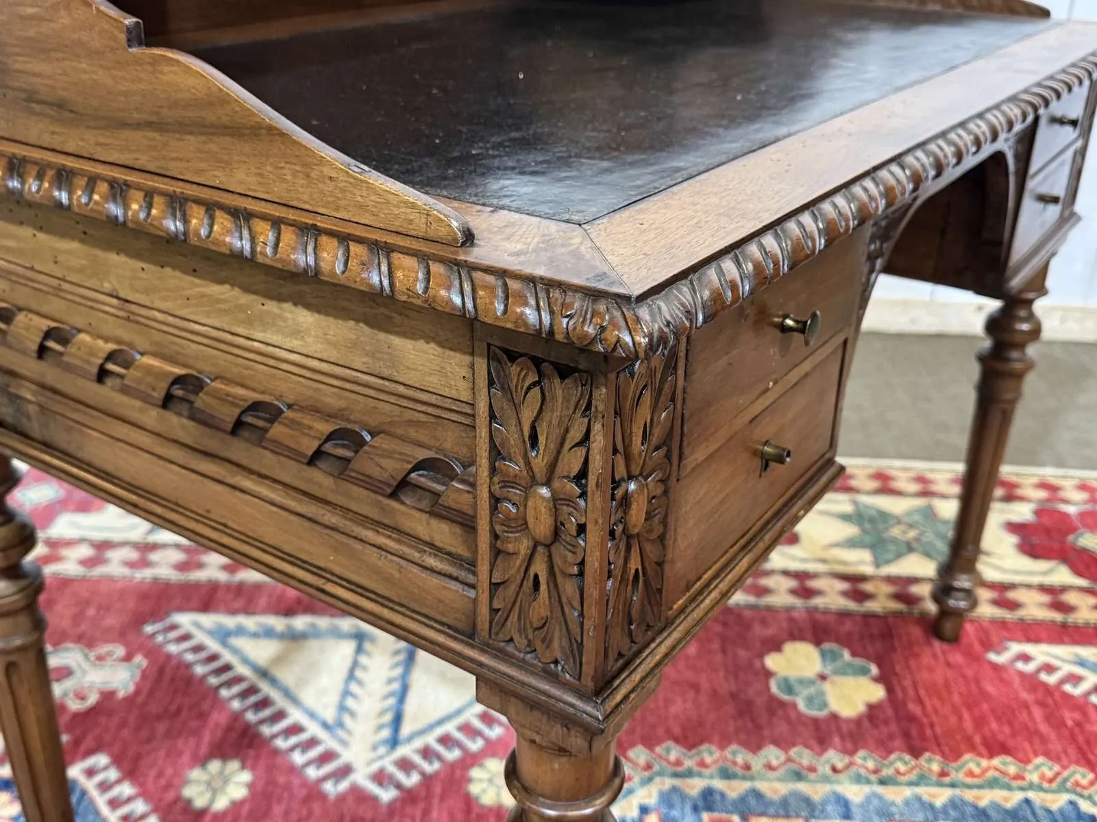 Louis XVI style desk from the late 19th century in walnut with a leather top.