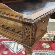 Louis XVI style desk from the late 19th century in walnut with a leather top.