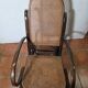 Curved wooden rocking chair with caning