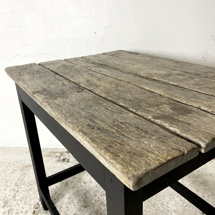 Old blackened wood work table and varnished top