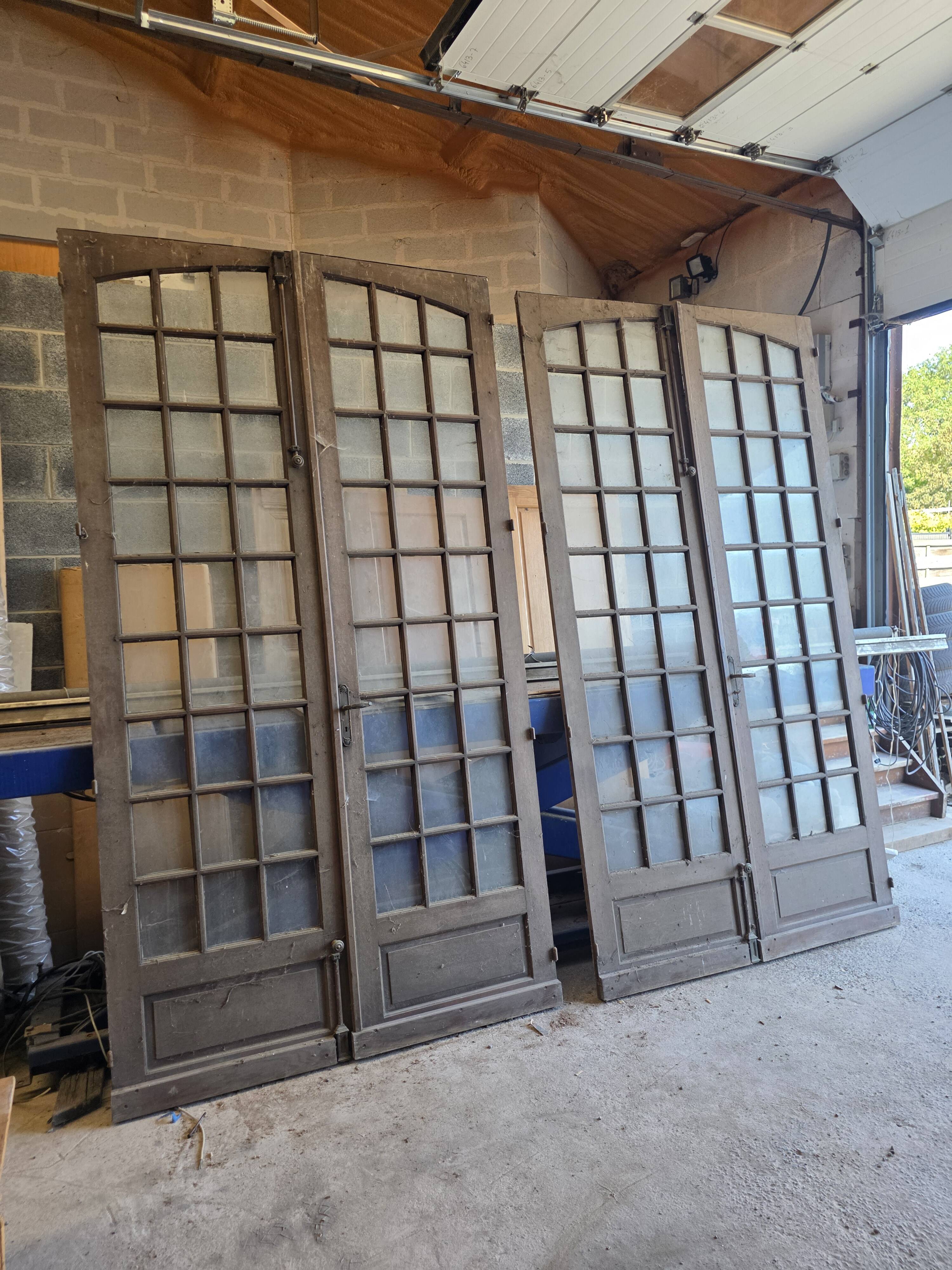 Two pairs of solid oak doors with small panes.