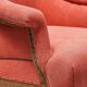 Napoleon III salon armchair in brick red linen with a tufted footrest.