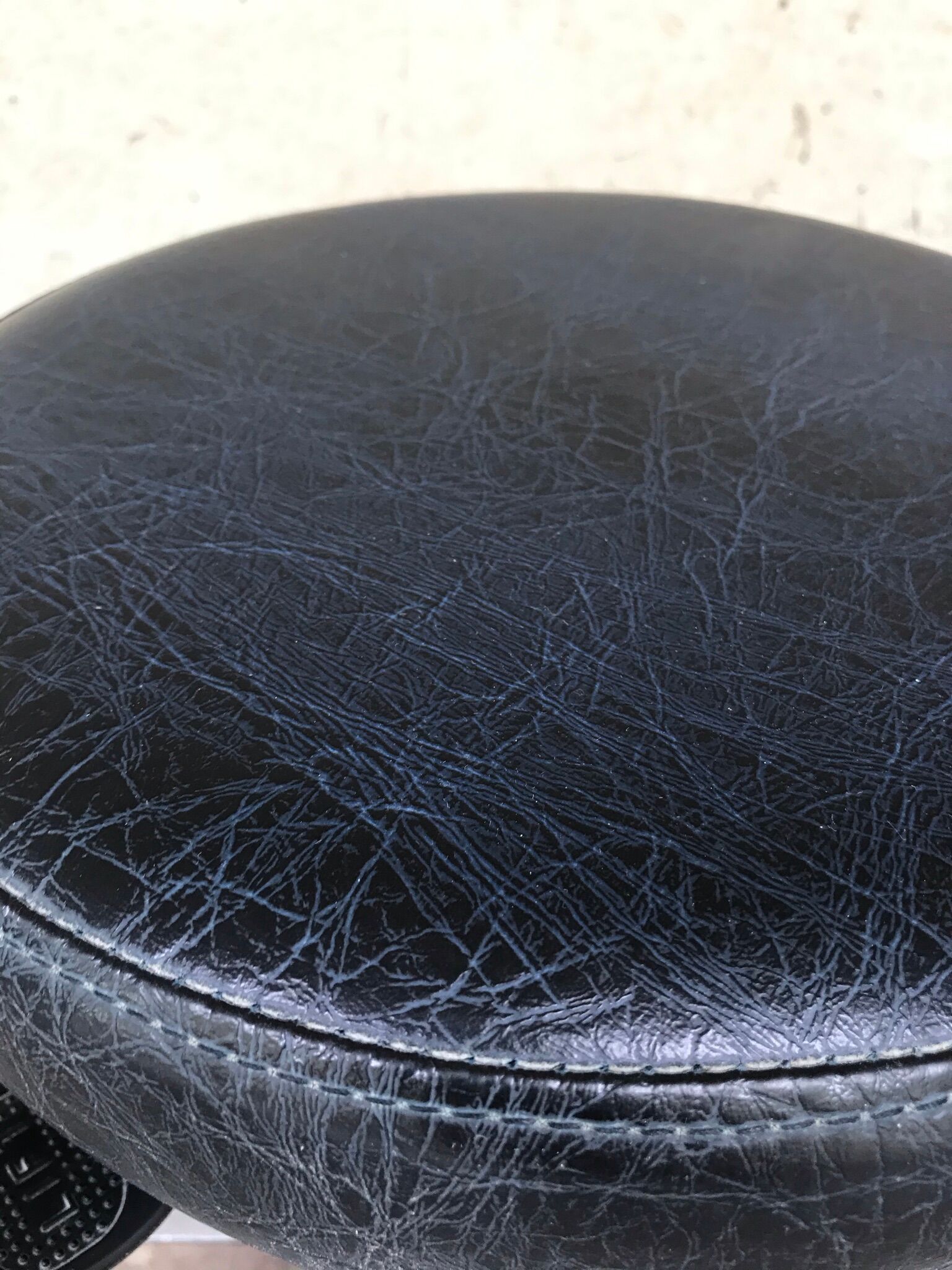 Stool on metal stand in star on wheels sitting round padded skaï bluish