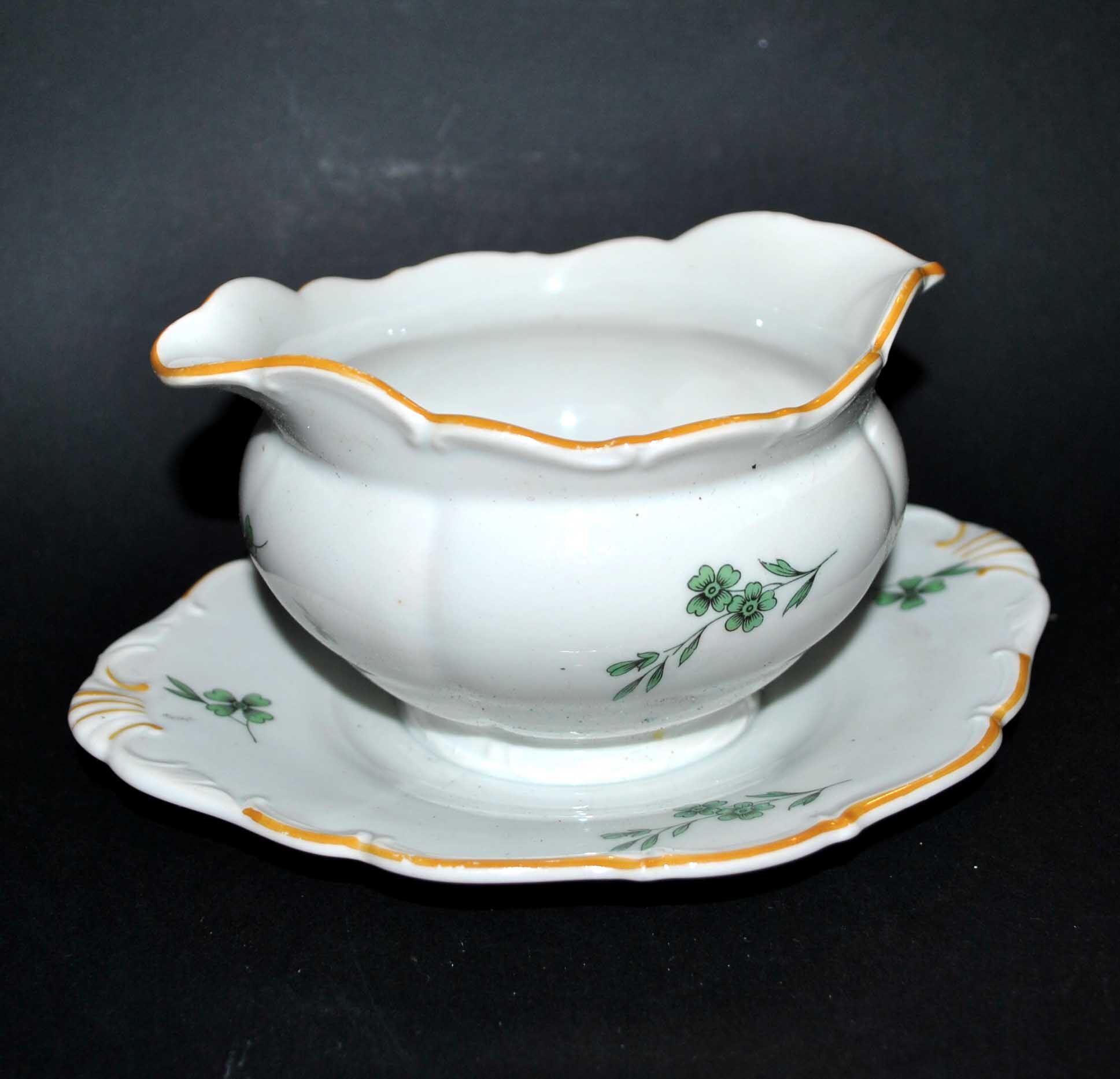 Vintage porcelain pouring saucière decorated with green clover