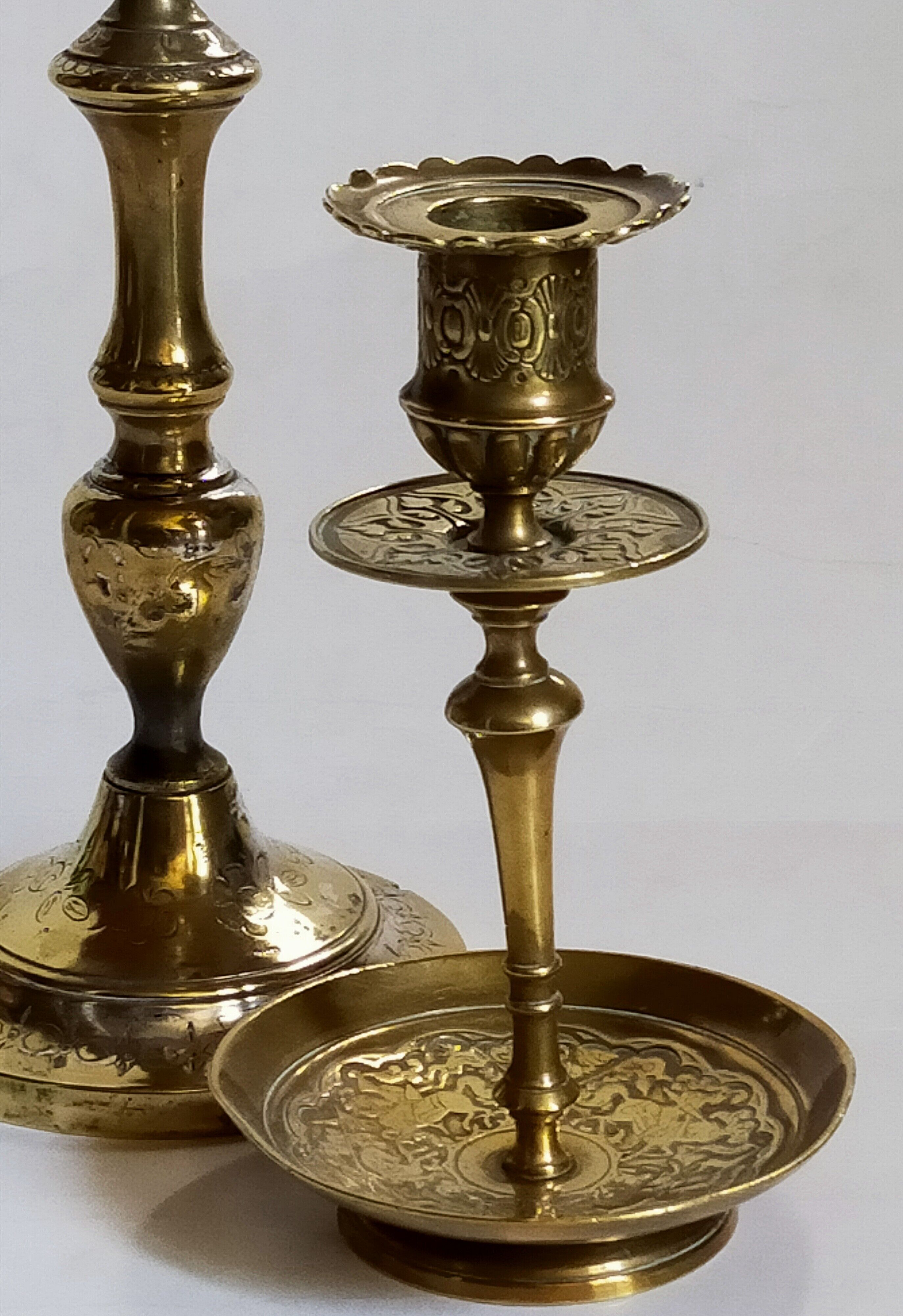 Duo of solid brass and gold metal candle holders worked old