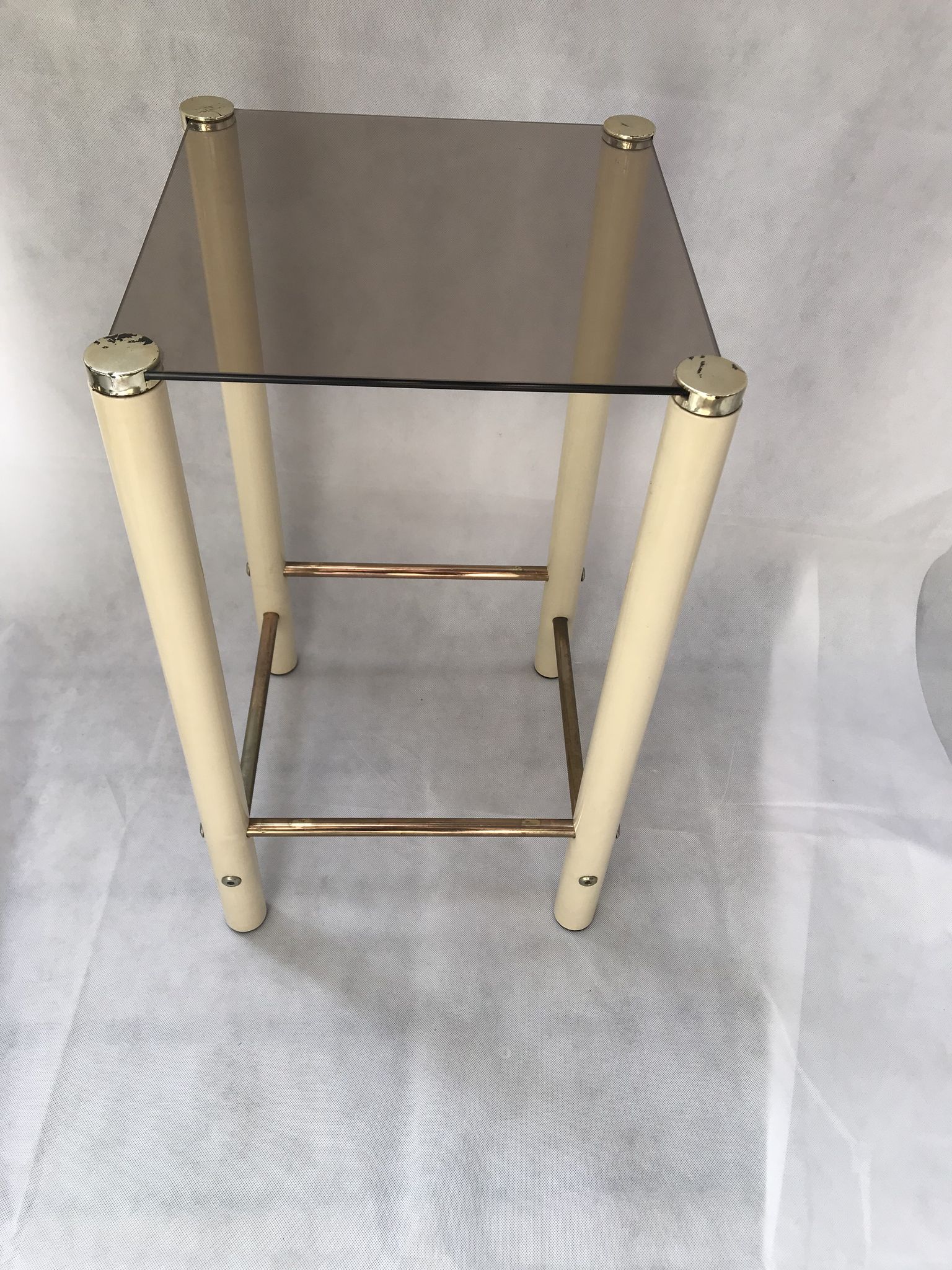 Square side table in metal and smoked glass.