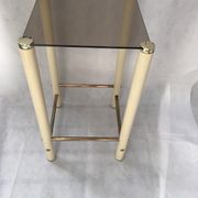 Square side table in metal and smoked glass.