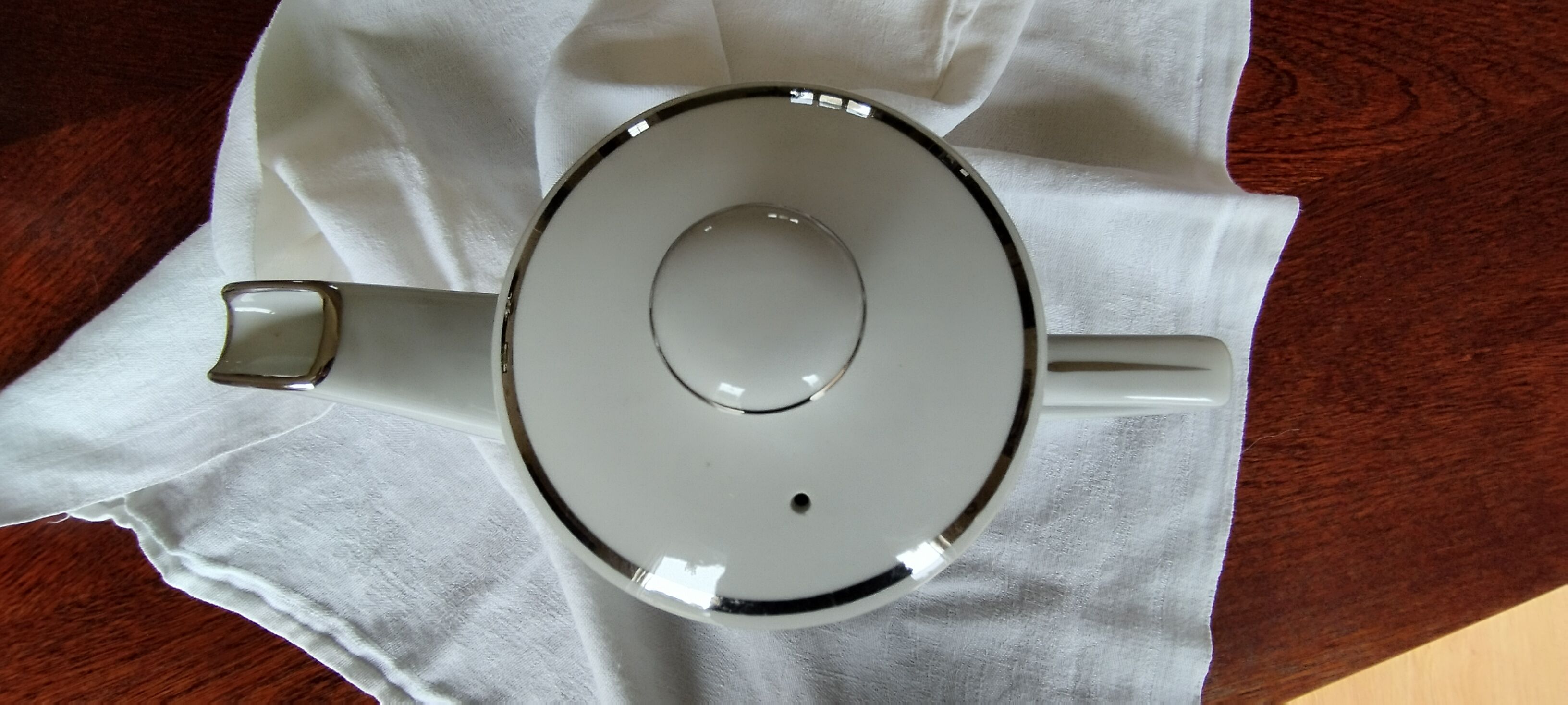 White and silver porcelain teapot