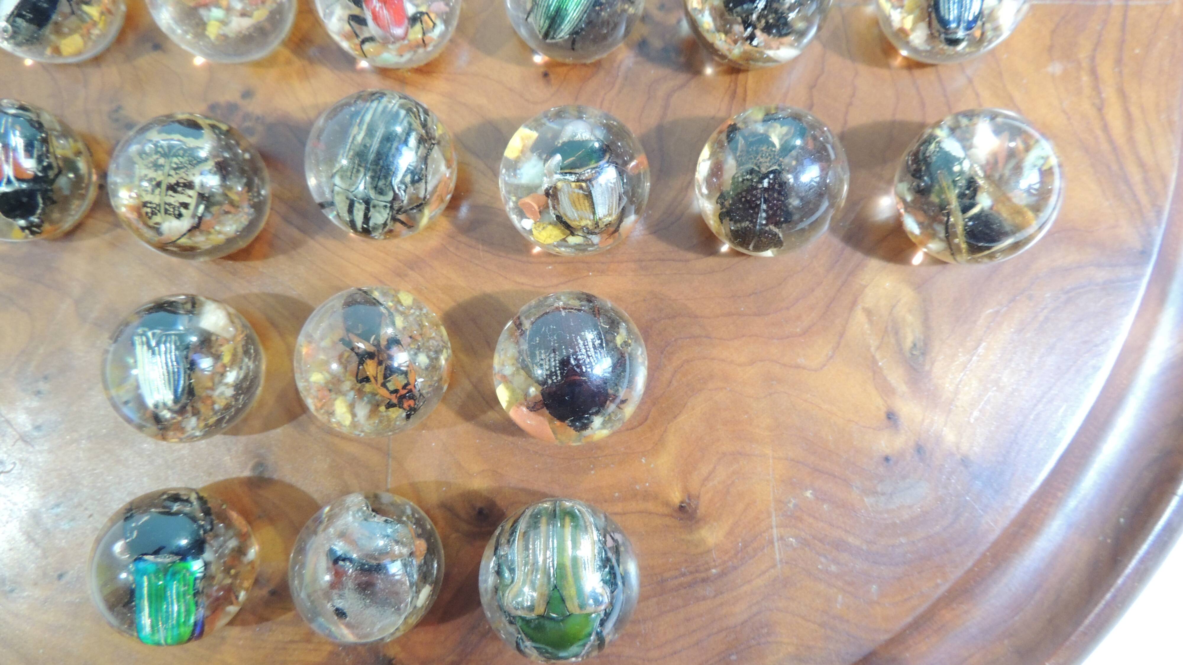 Vintage wooden solitaire game with resin balls and insects – Madaga