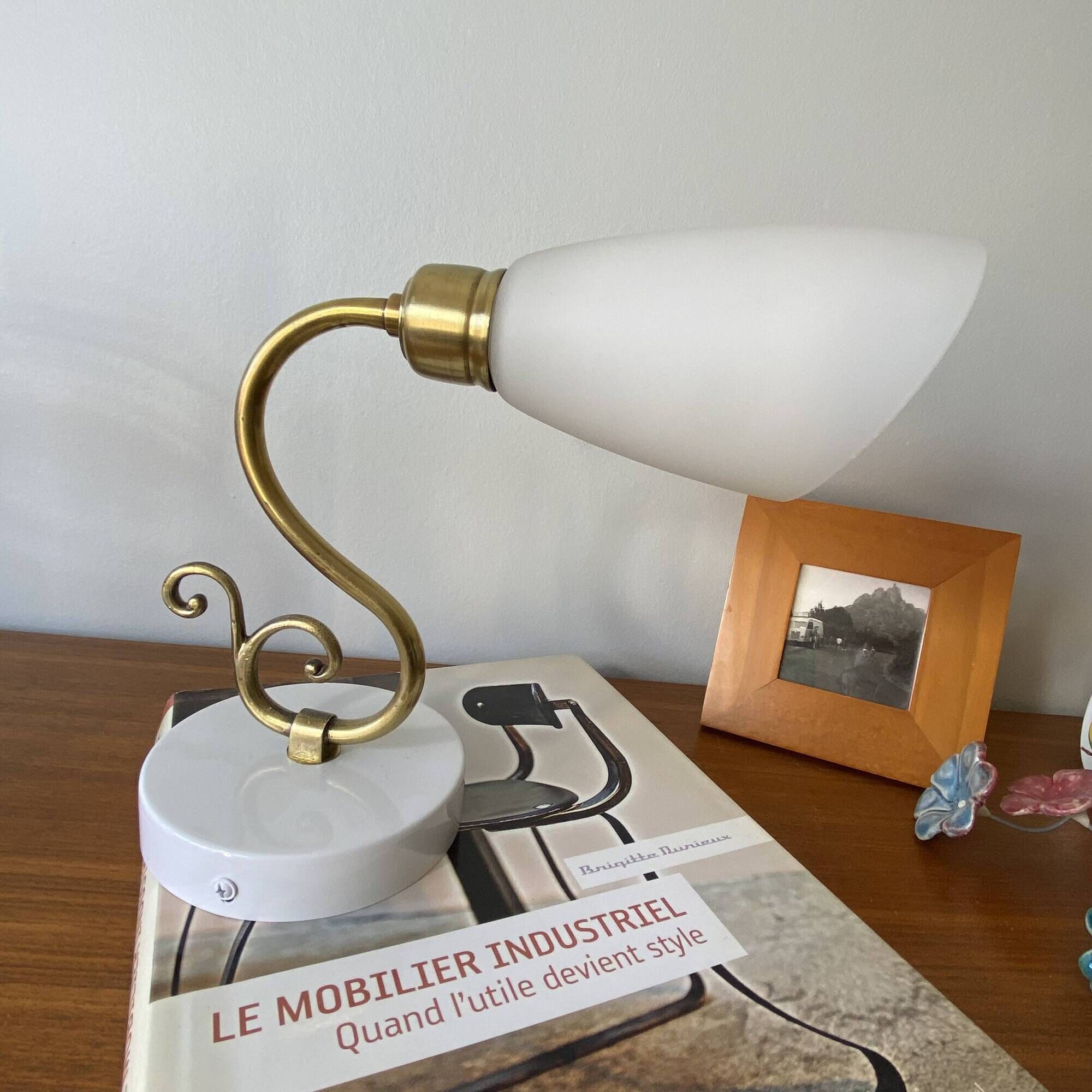 Pair of brass swan neck wall lights with white glass shades.