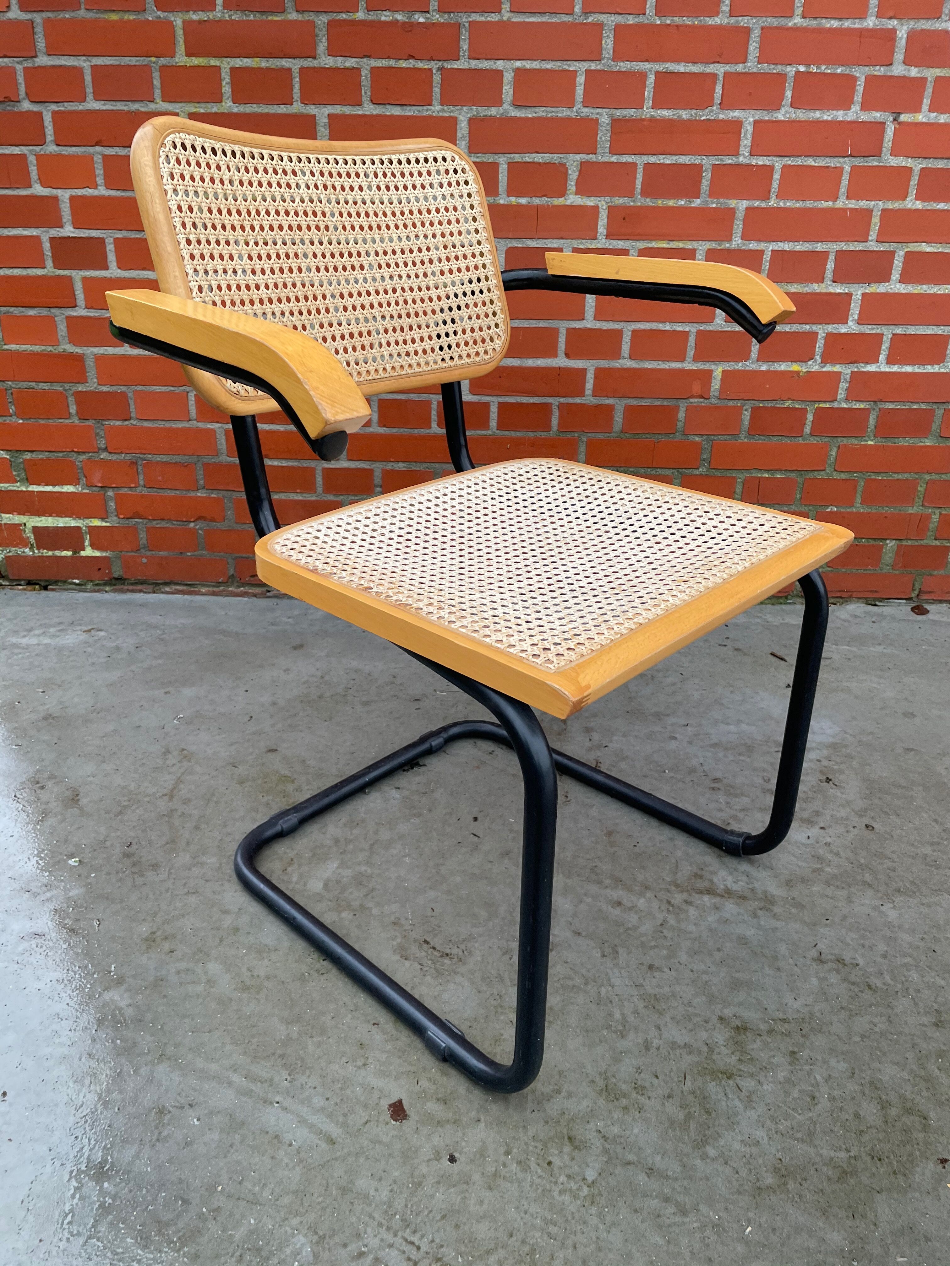 Cesca model chair designed by Marcel Breuer with black-framed armrests