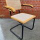 Cesca model chair designed by Marcel Breuer with black-framed armrests