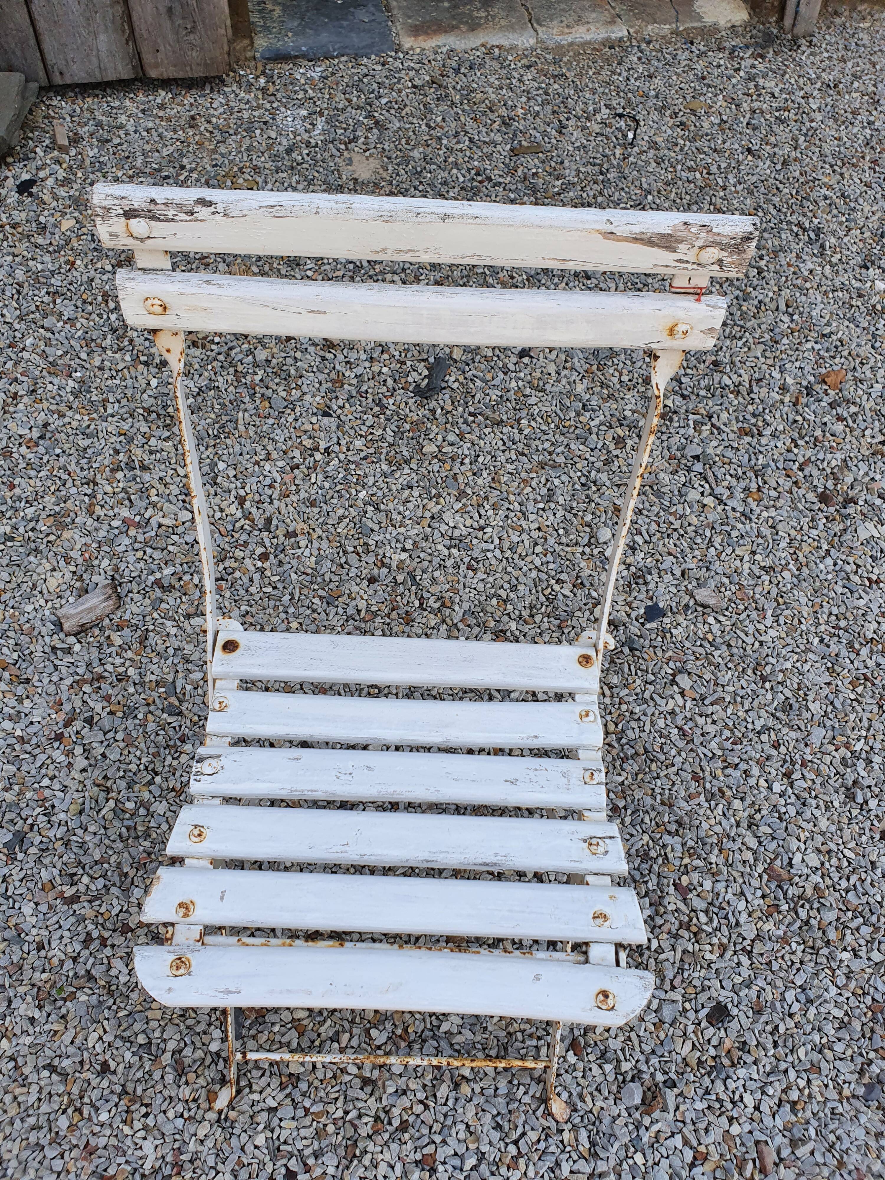 Wooden slatted garden chair with wooden slats and iron feet