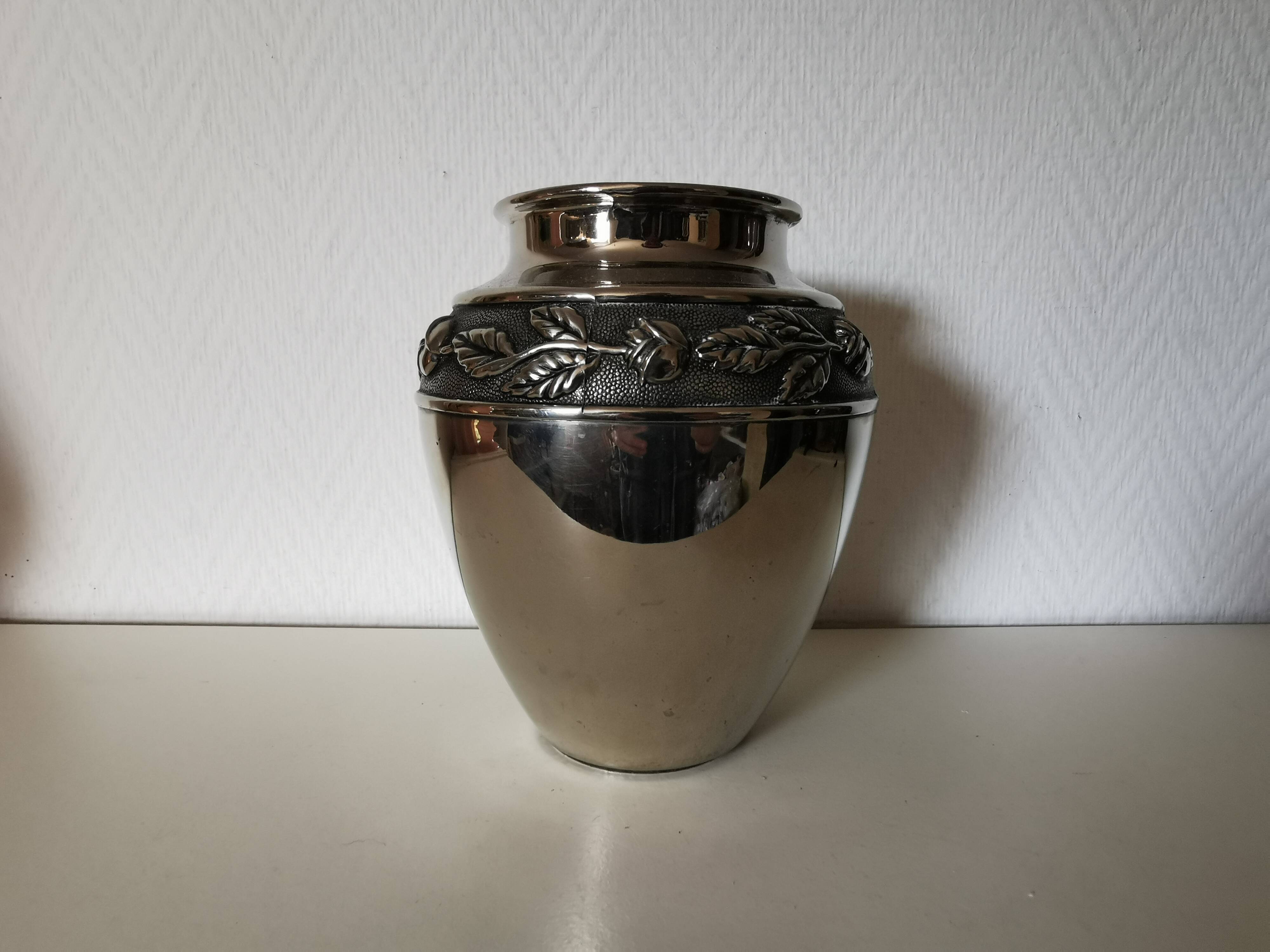 metal vase, flowers in relief