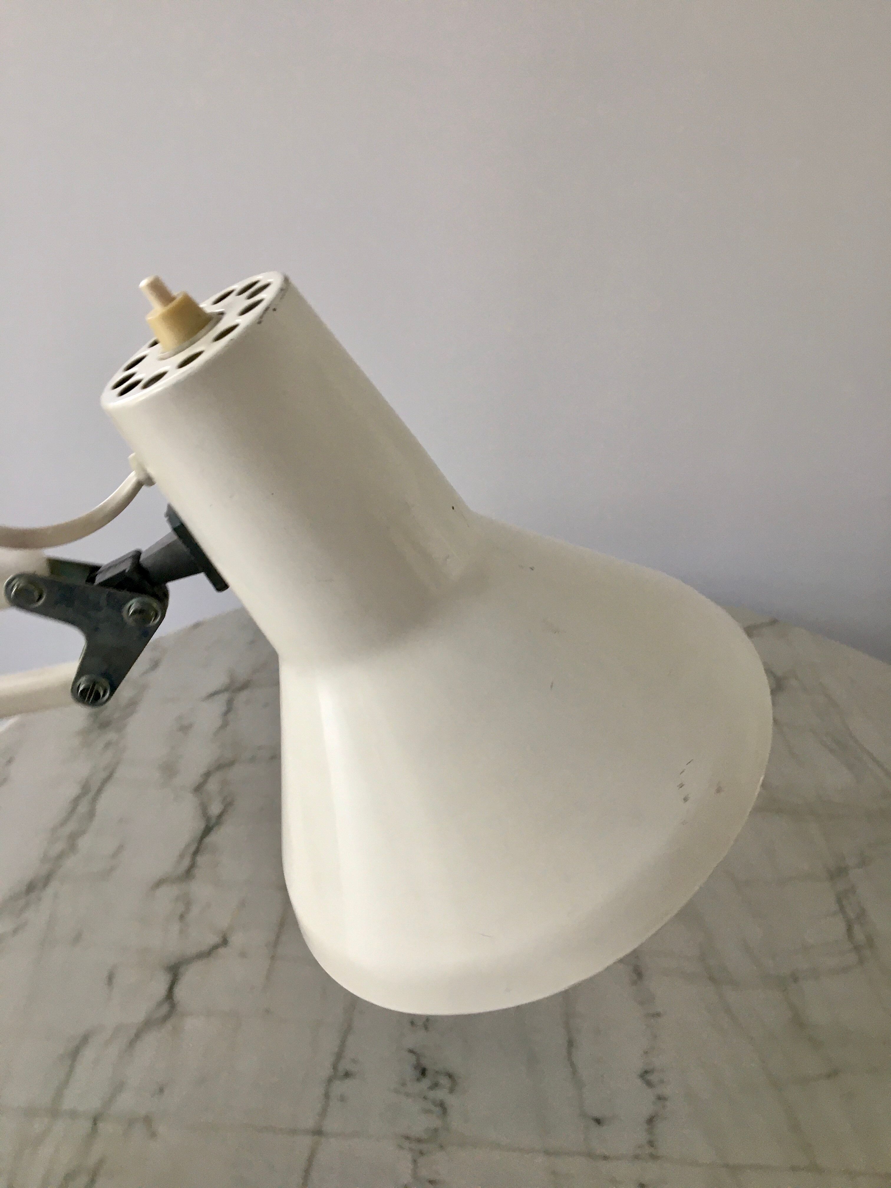 Off-white articulated architect lamp.