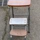 Folding stool in formica with a wood effect.