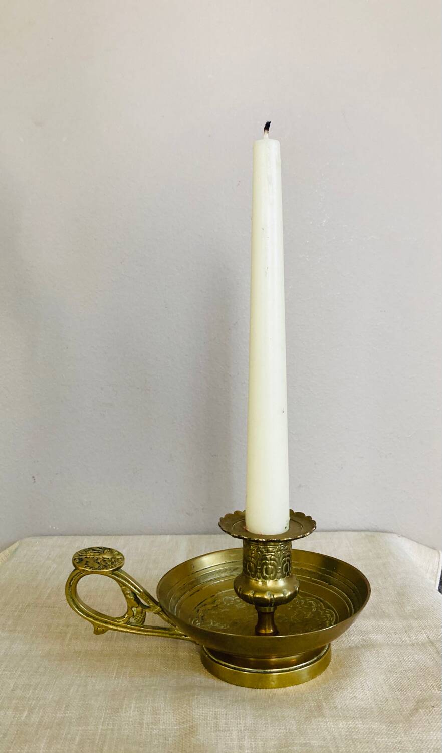 20th century chiseled brass socket candle holder representing Horsemen in armor