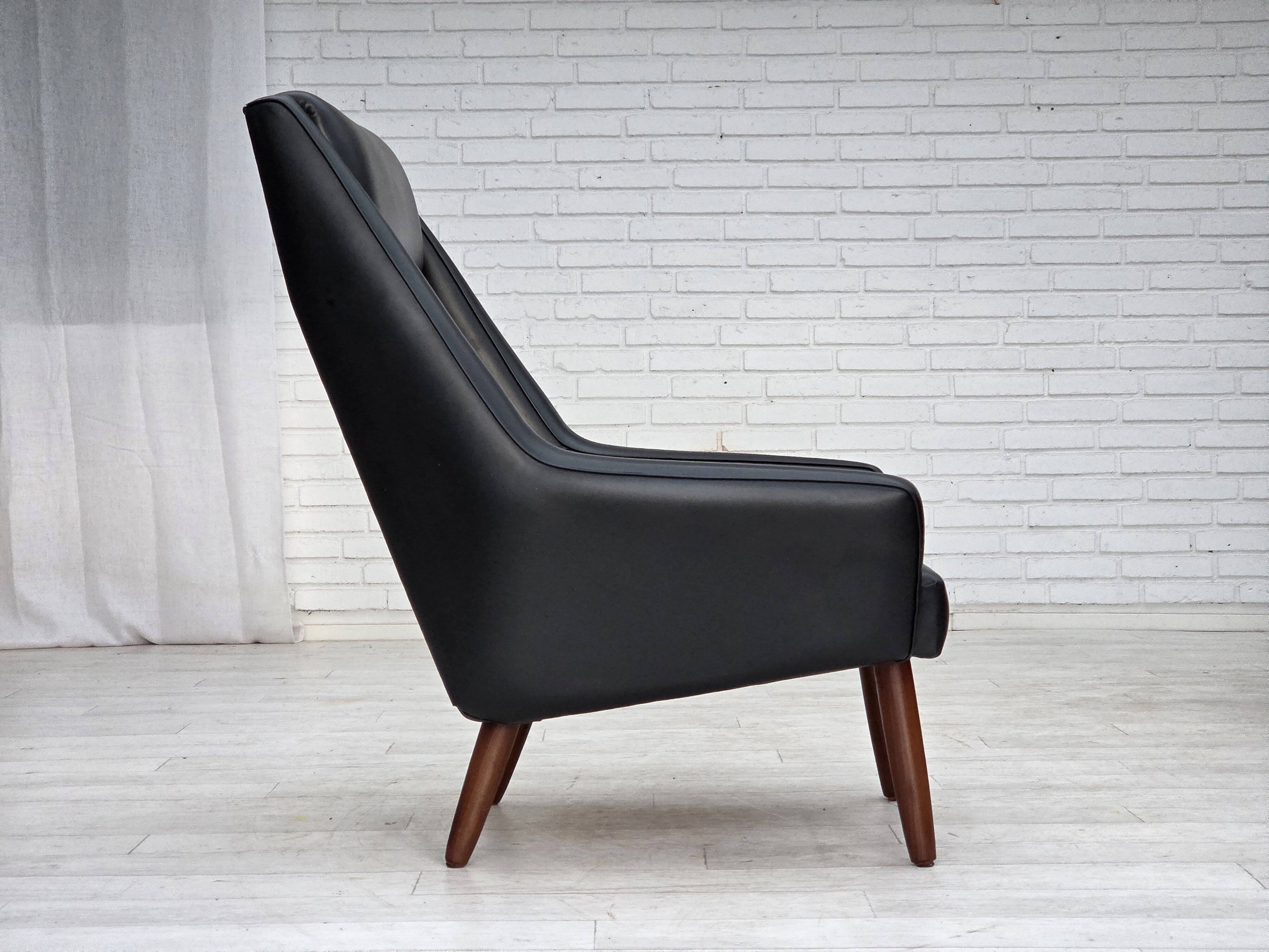 1970s, Danish highback armchair, black artificial leather, teak wood legs.