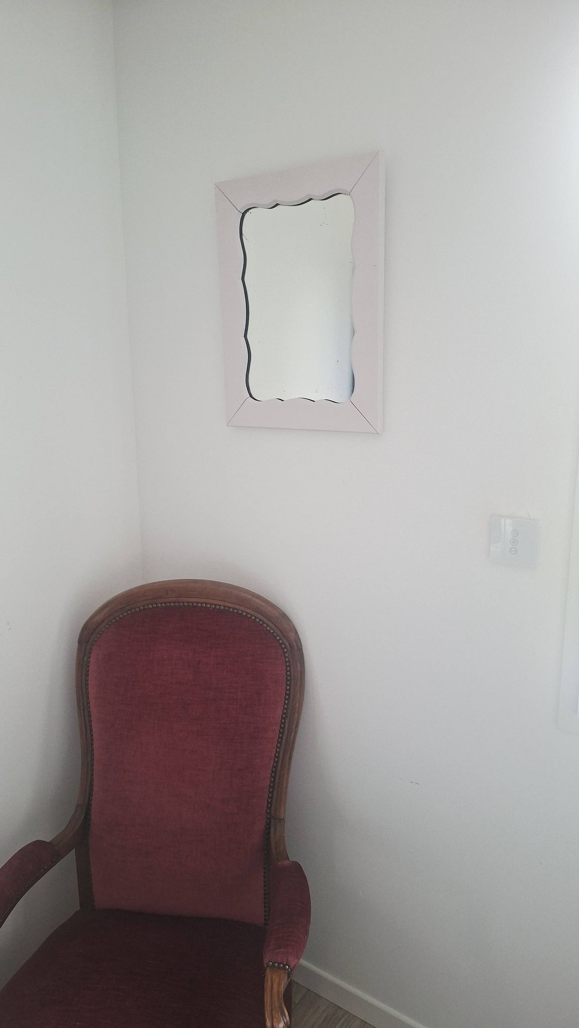 Mid-20th century rectangular wall mirror with a powder pink frame.