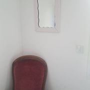 Mid-20th century rectangular wall mirror with a powder pink frame.