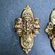 Pair of bronze wall sconces with mask, signed L. Pinet, Art Nouveau period.