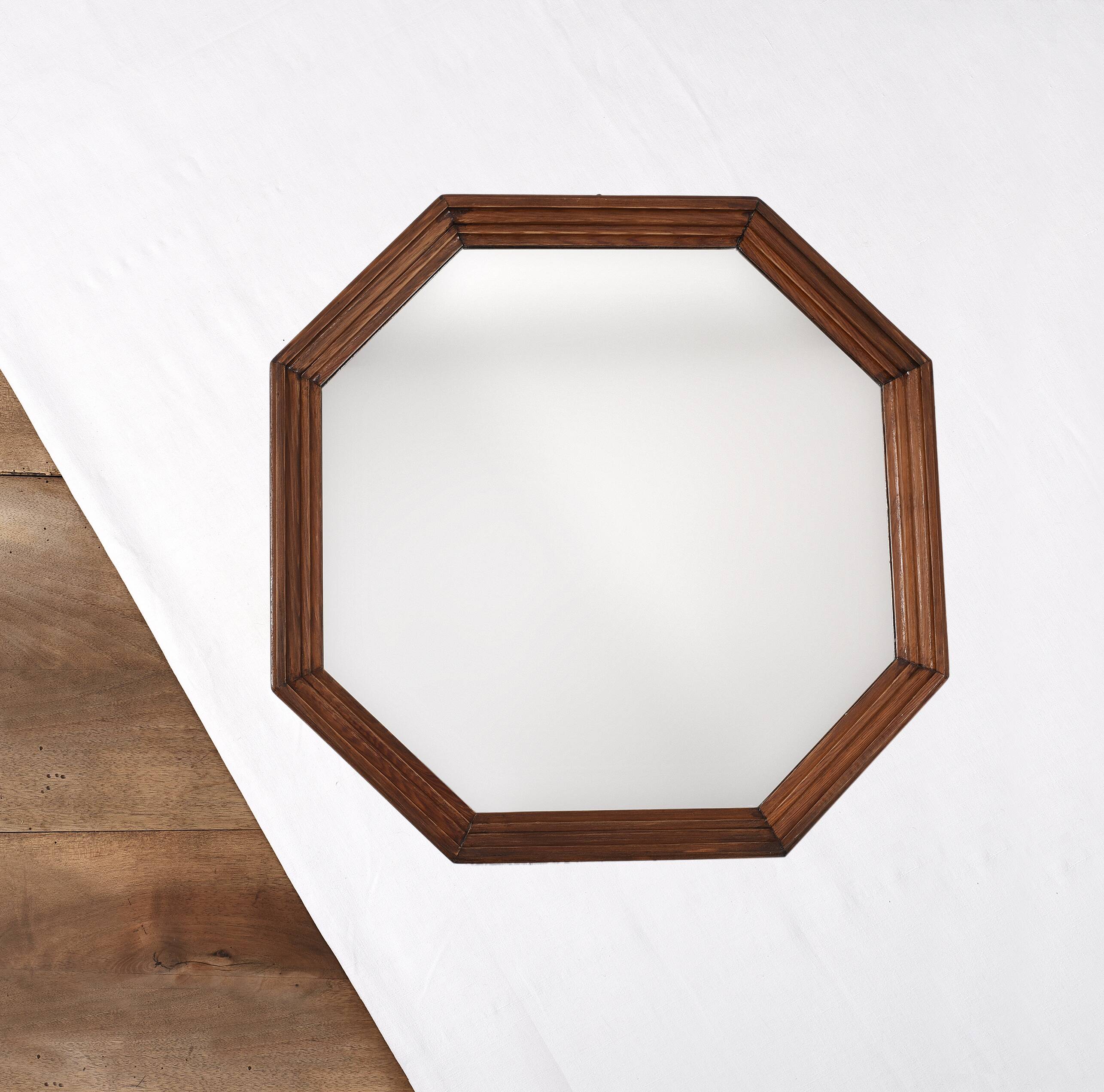 Old second-hand wooden mirror, octagonal shape.