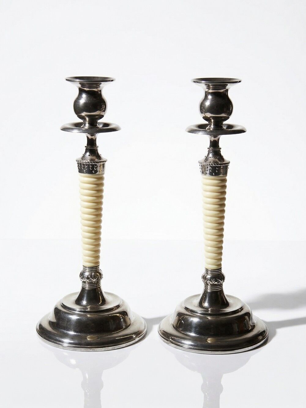 Pair of vintage candlestick holders in silver-plated metal with ivory-style plastic.