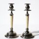 Pair of vintage candlestick holders in silver-plated metal with ivory-style plastic.