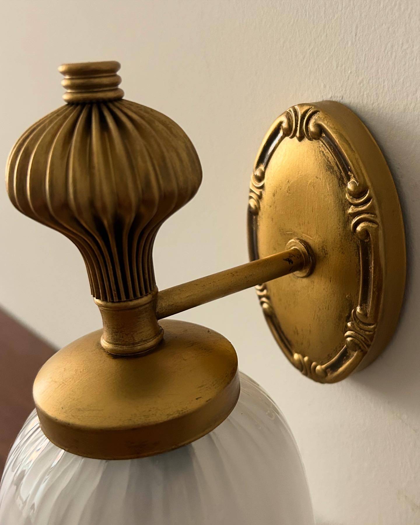Gold wall sconce with ecru globe