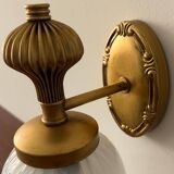 Gold wall sconce with ecru globe