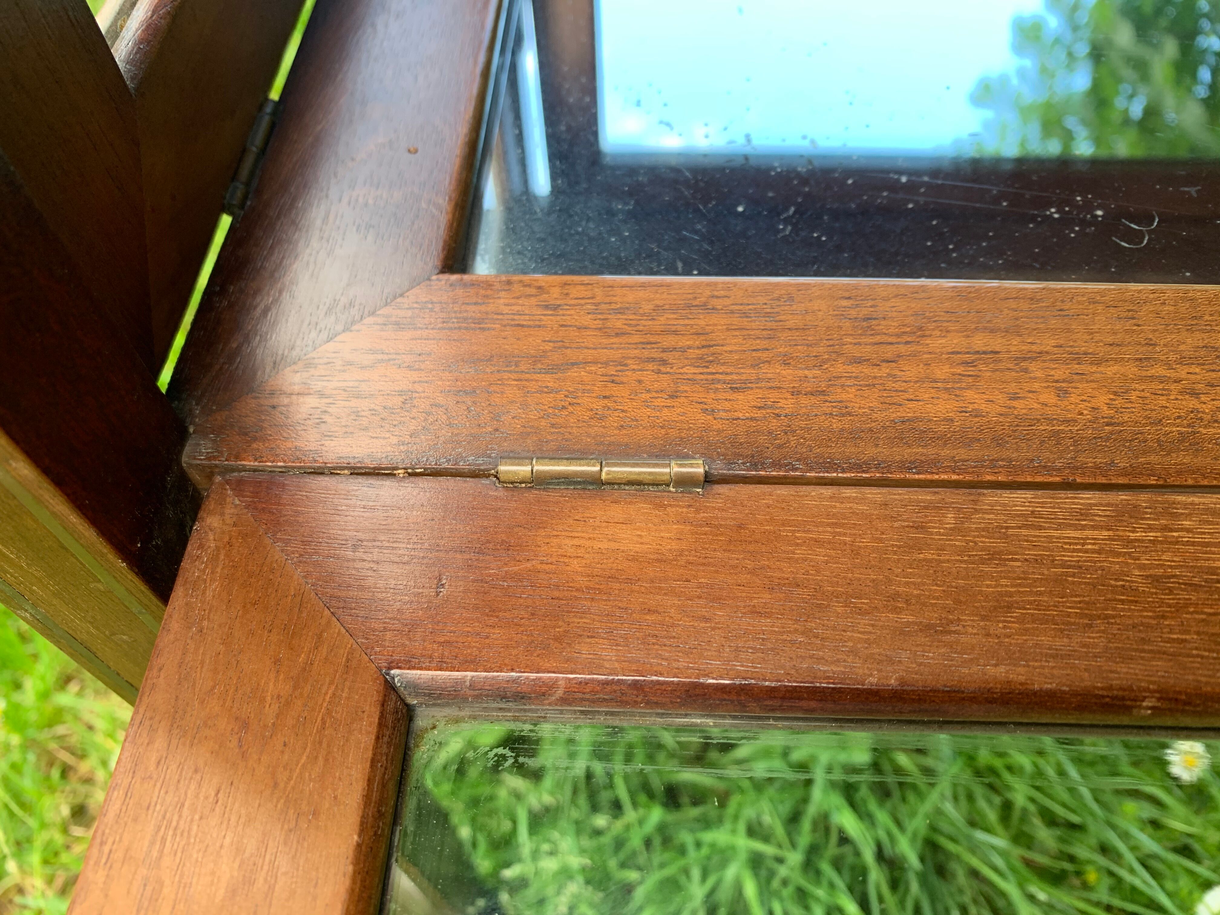 Glass-enclosed old tea table with wooden tray, bronze and brass