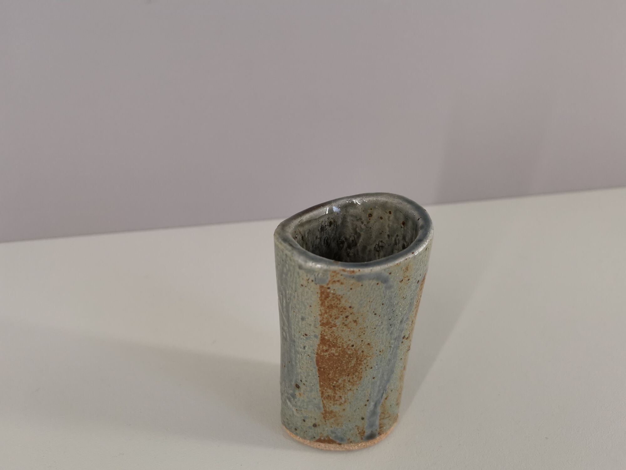 Signed vase in enamelled sandstone with stylized face
