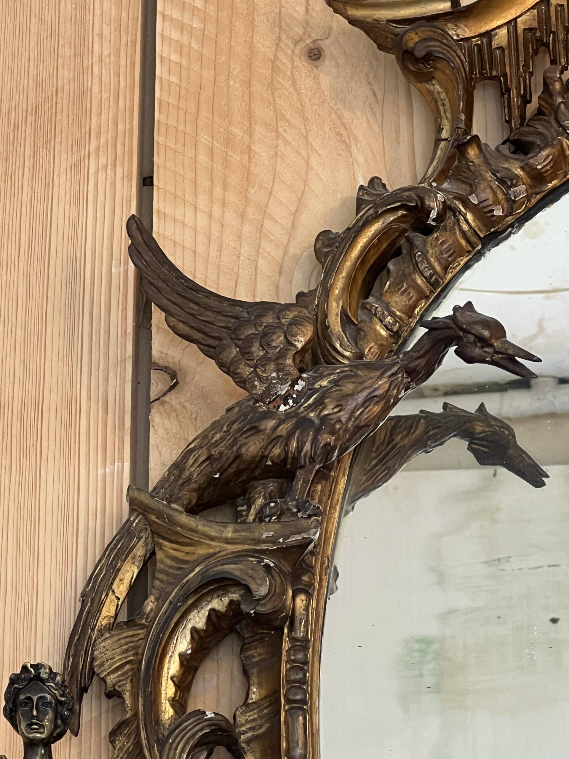 Large gilded wooden mirror, richly carved with winged dragons, 19th century
