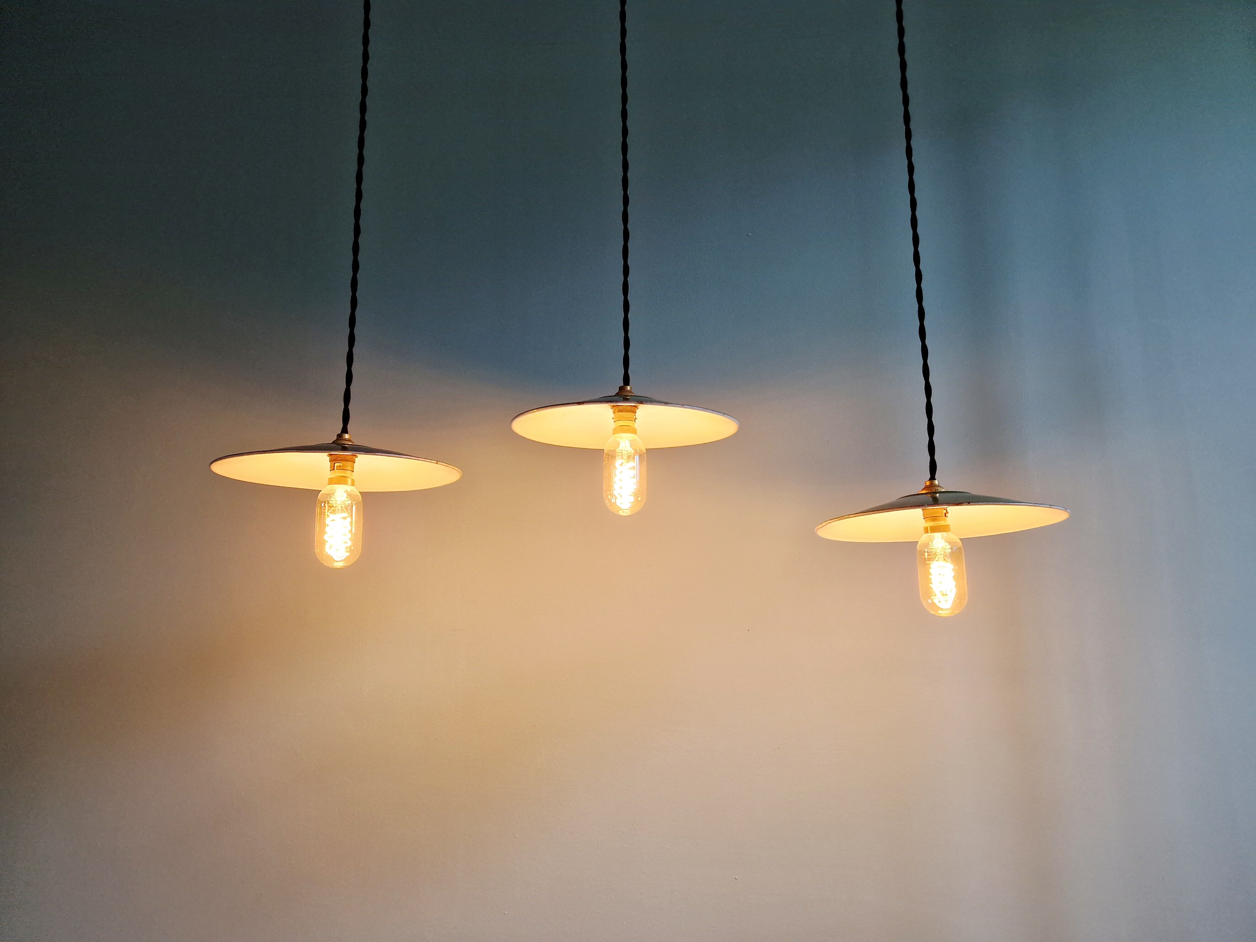 Trio of large industrial suspensions in green enamelled sheet metal.