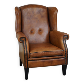 Large sheepskin leather wingback armchair in good condition, English style